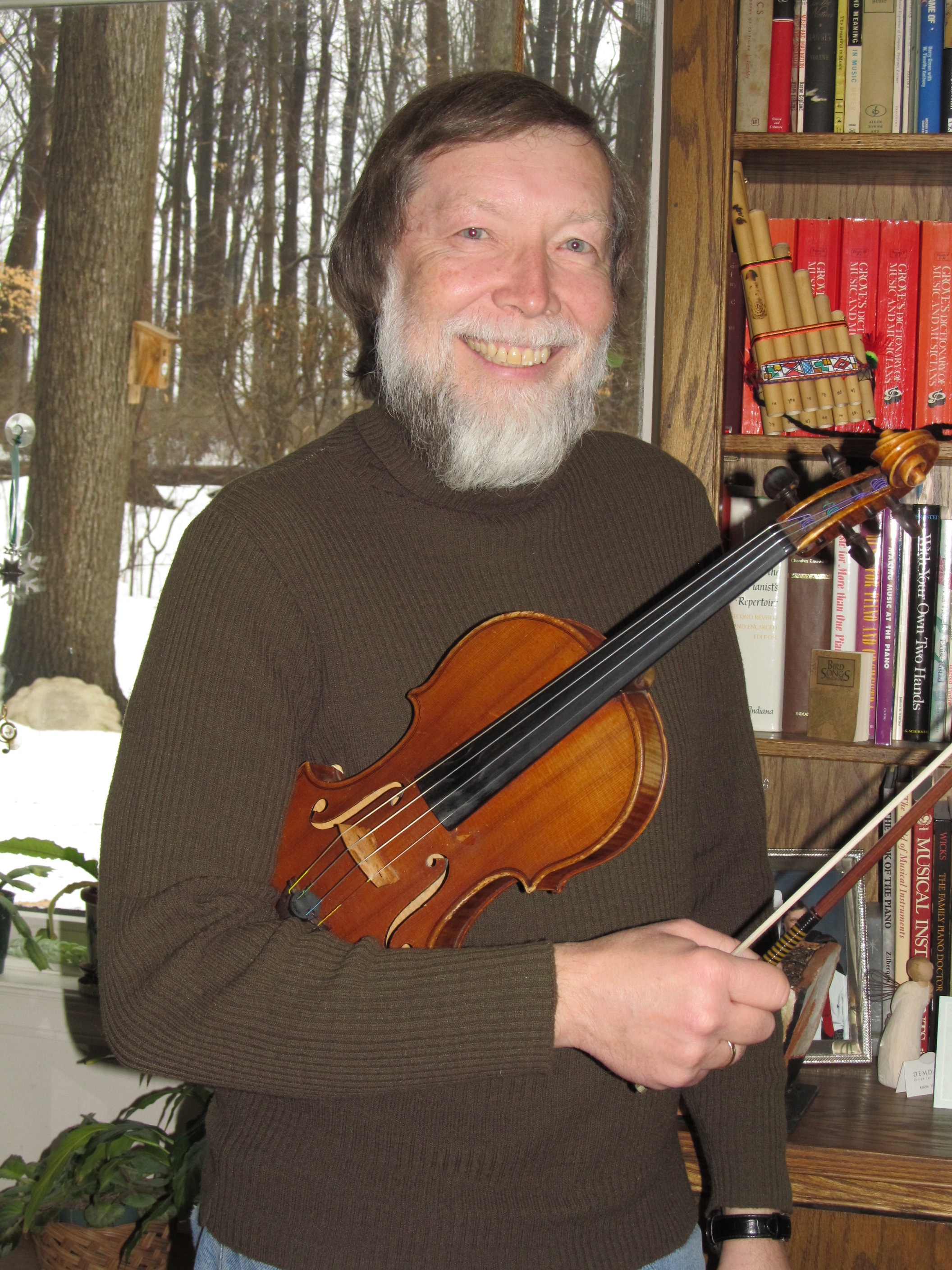 Martin stands with his violin in the studio