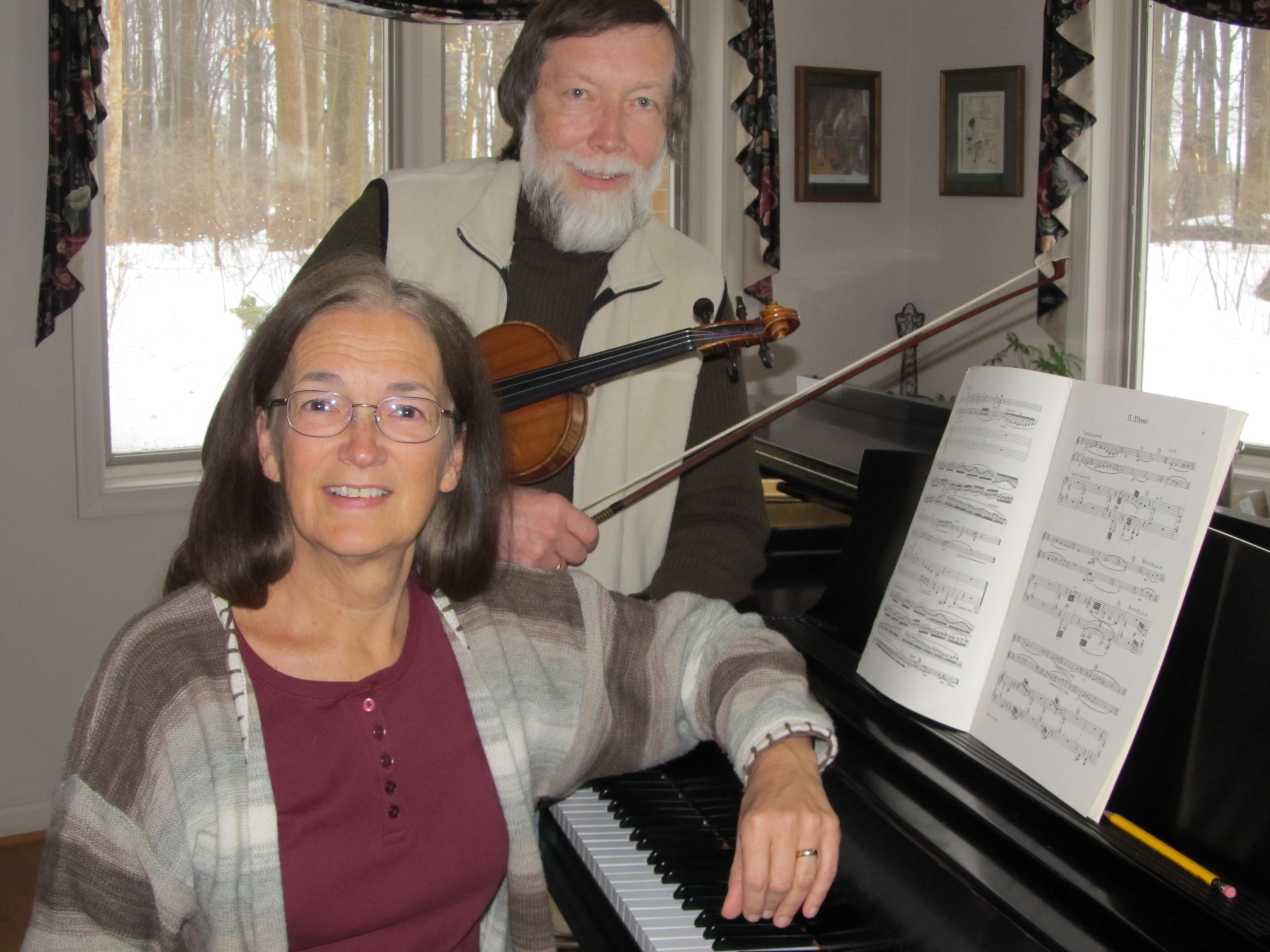 Donna sits at the piano with Martin holding a violin